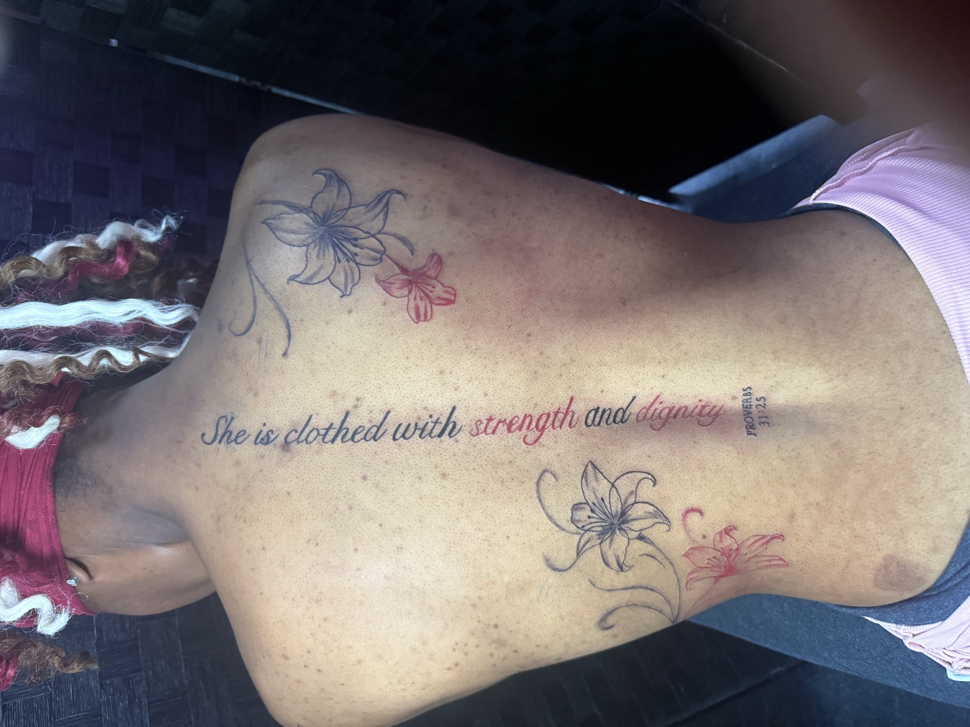 Lettering + Script lilies tattoo on Upper Back by AmenInkLLC on TattMe