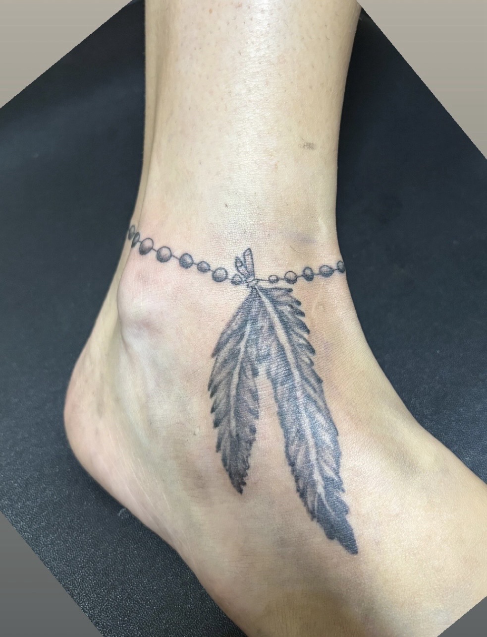 Black & Grey + Fine Line feathers tattoo on Ankle by TattedbyJayden on TattMe
