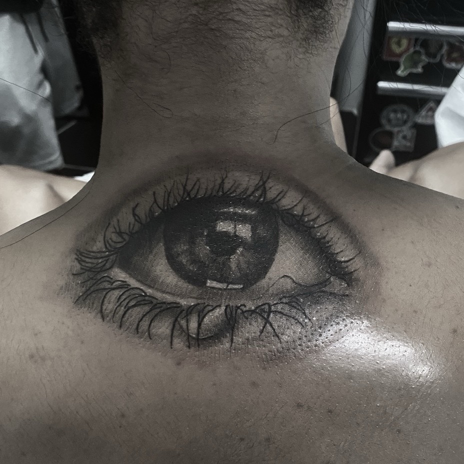 Black & Grey + Portrait Realism eye tattoo on Upper Back by Tattoos_By_Danny_Cruz on TattMe
