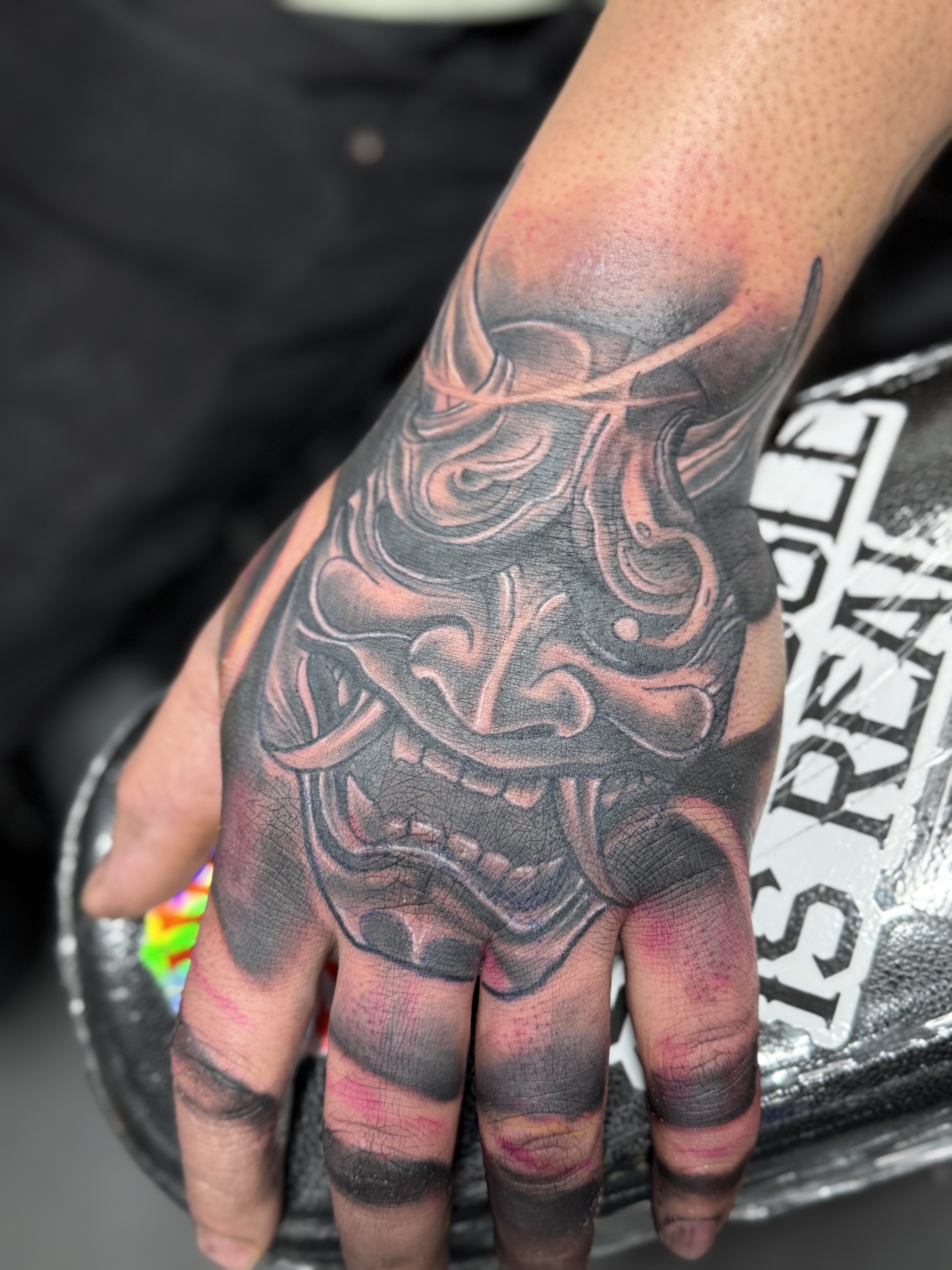Black & Grey hanya mask tattoo on Hand by needleworks_tattoo_studio on TattMe