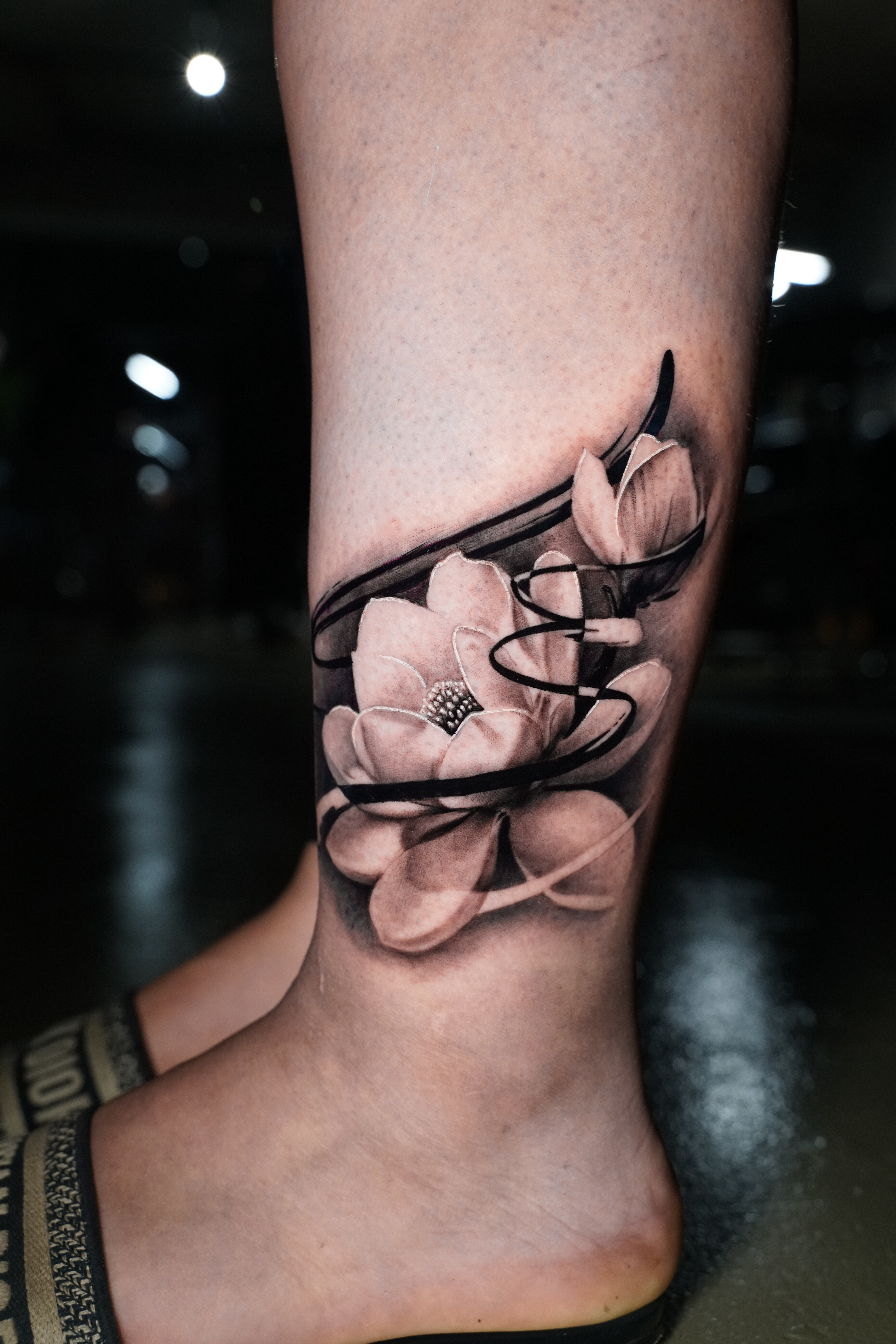 Surrealism + Black & Grey lotus tattoo on Calf by TATMANERC on TattMe