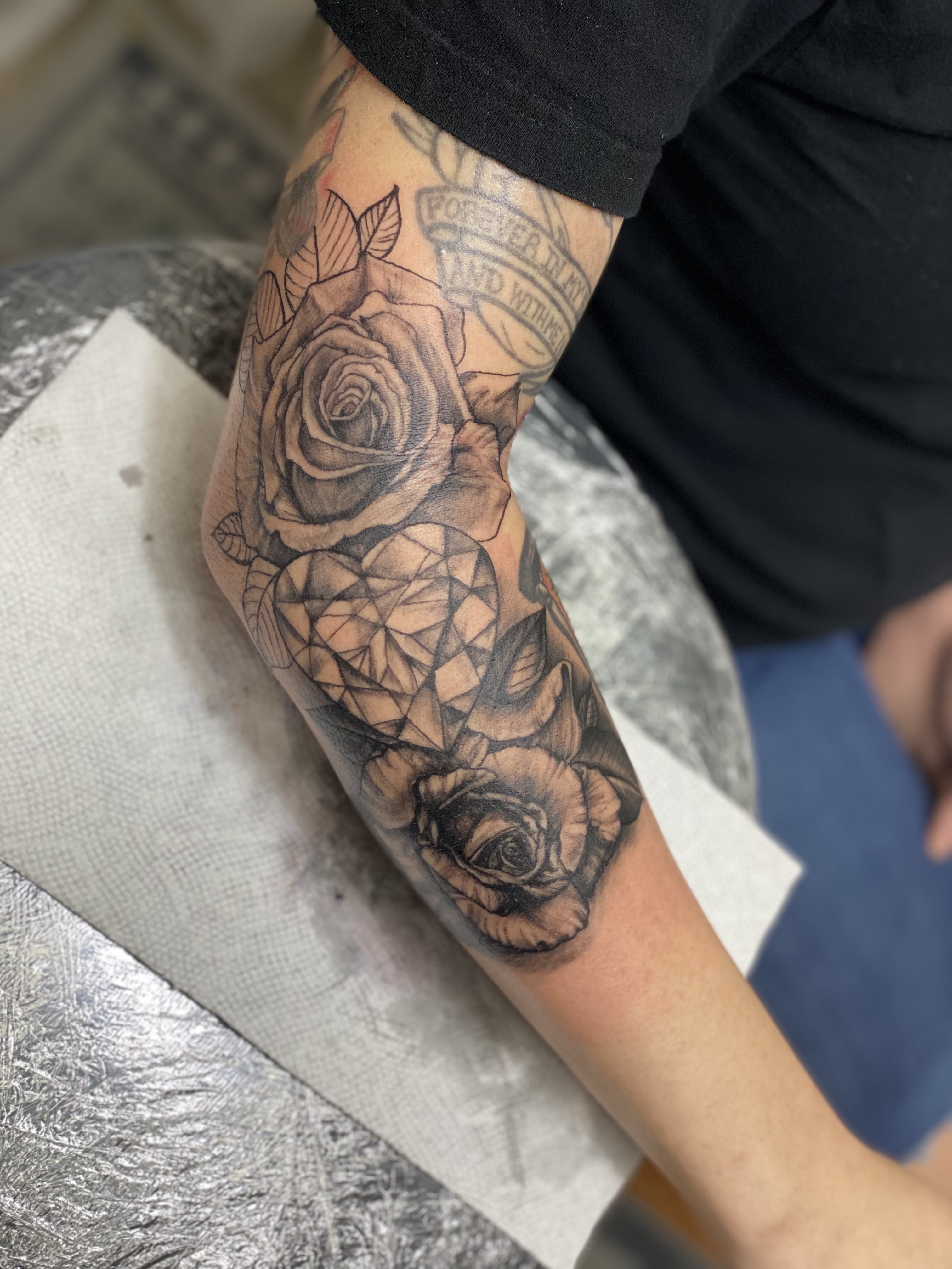 Black & Grey + Floral roses tattoo on Elbow by 438Star on TattMe