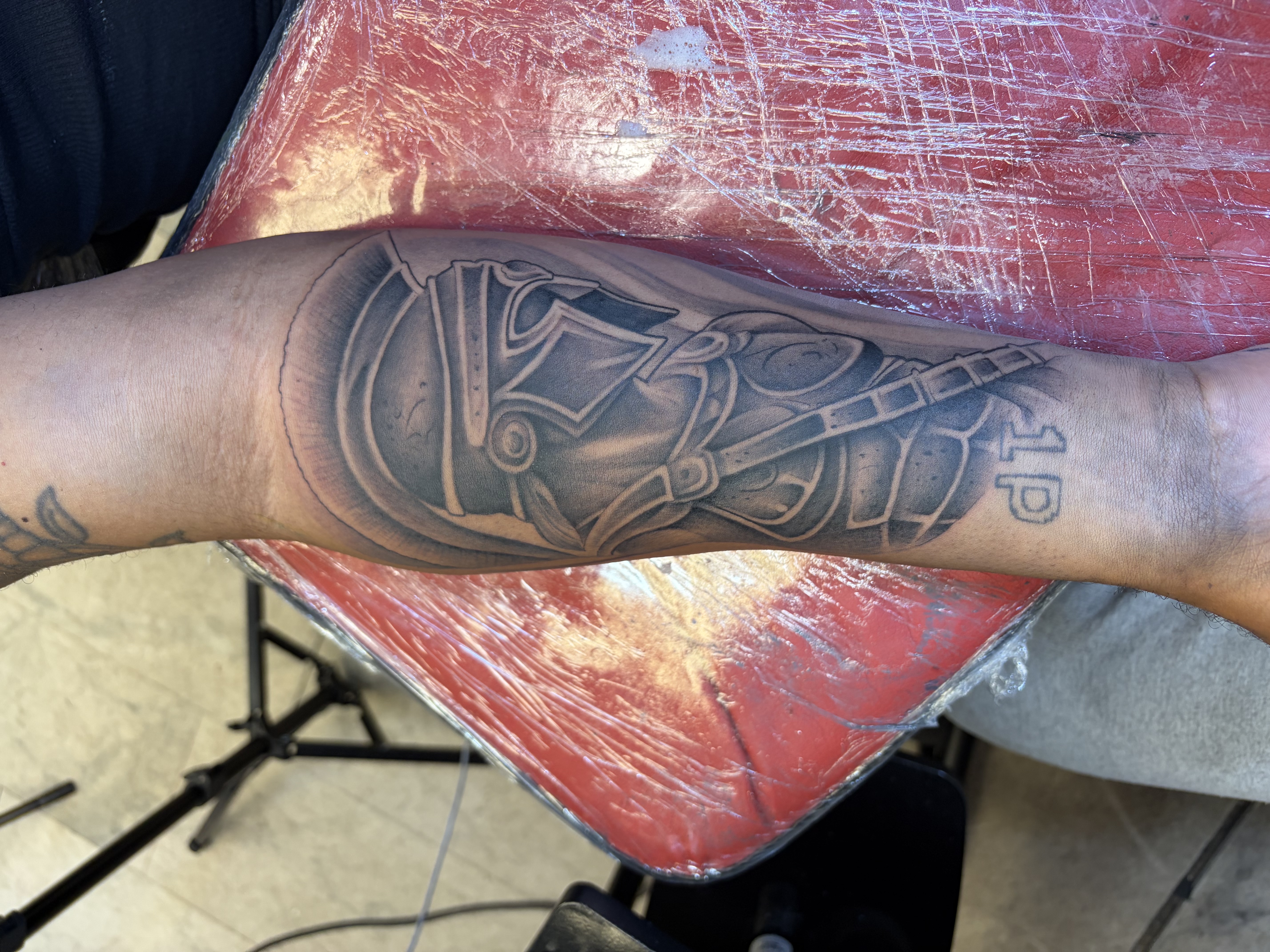 Black & Grey + Illustrative helmet tattoo on Forearm by 100inkz on TattMe