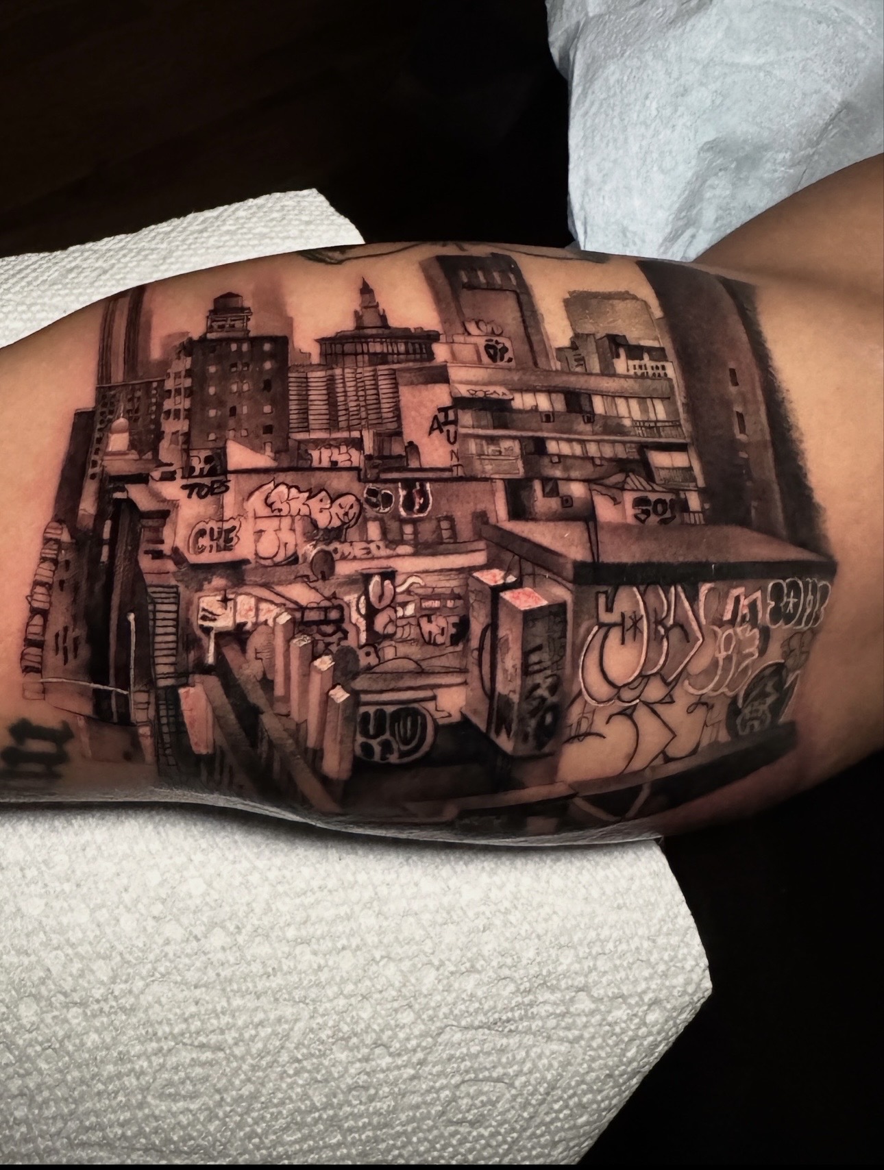 Black & Grey + Illustrative cityscape tattoo on Upper Arm by D-Artist on TattMe
