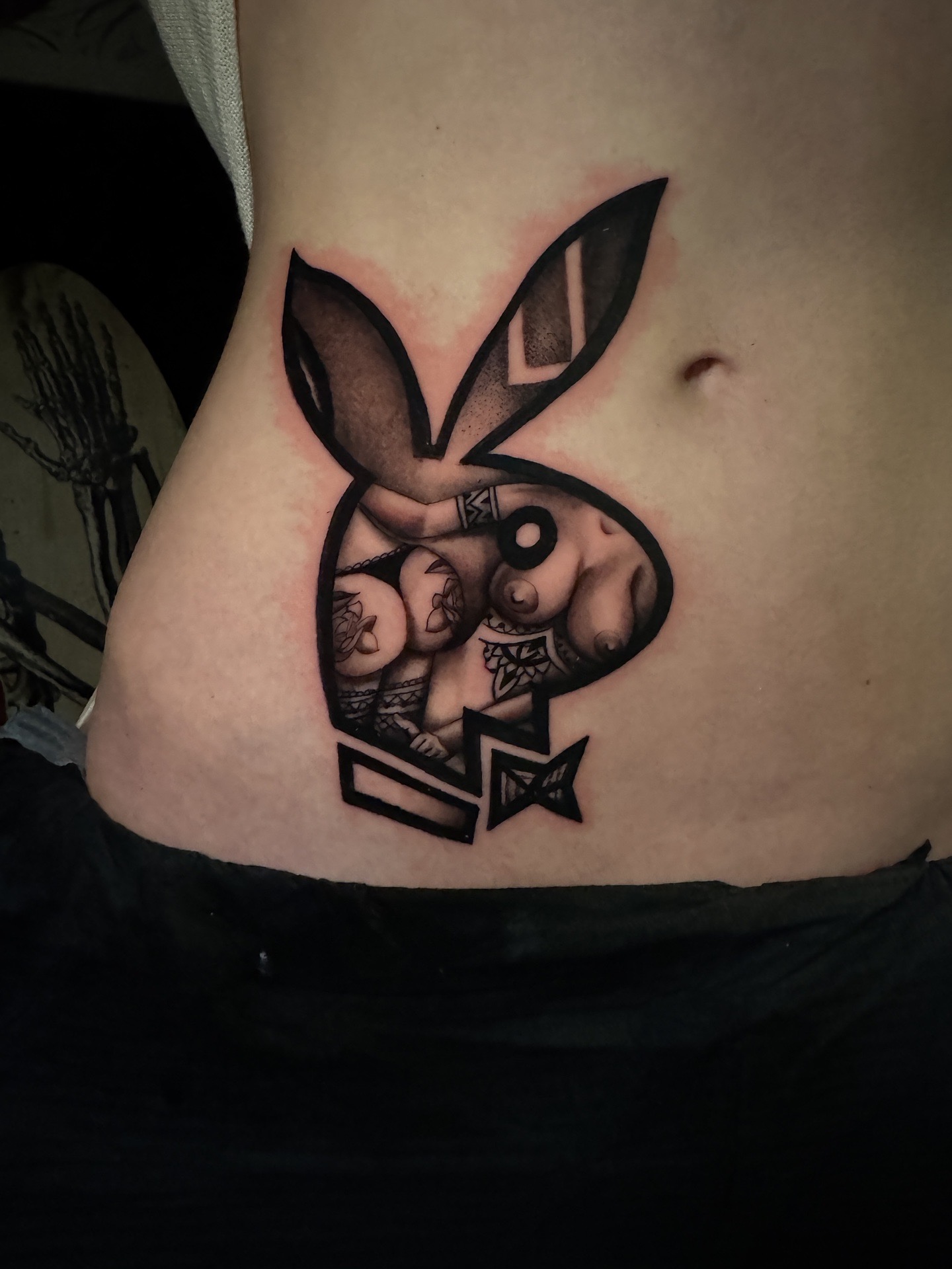 Black & Grey + Illustrative playboy bunny tattoo on Ribs by D-Artist on TattMe