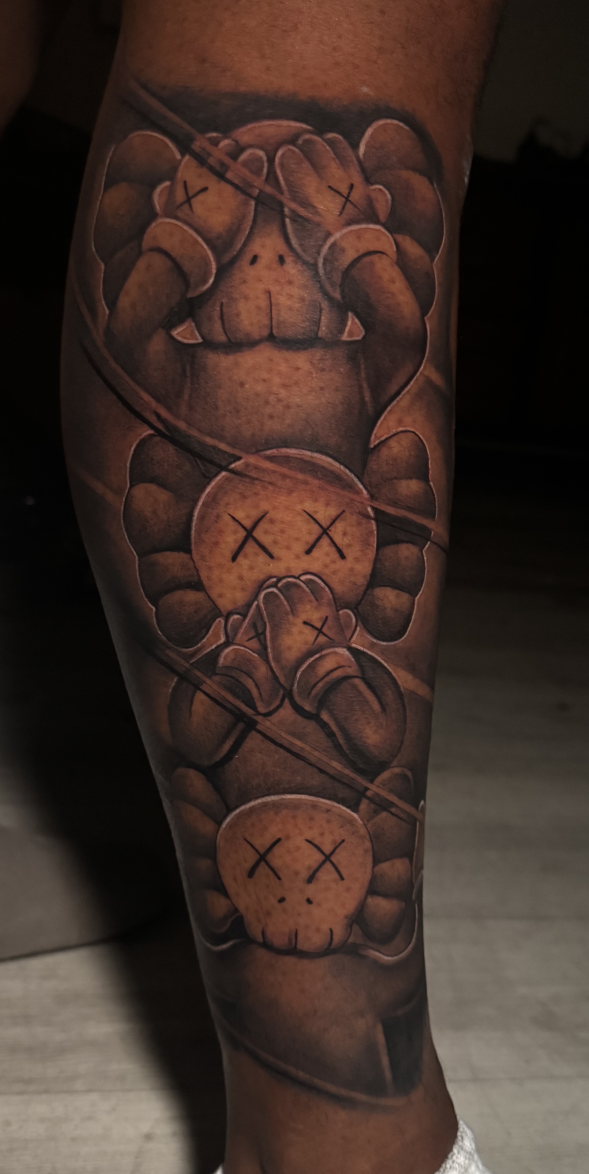 Pop Culture + Black & Grey kaws tattoo on Calf by D-Artist on TattMe