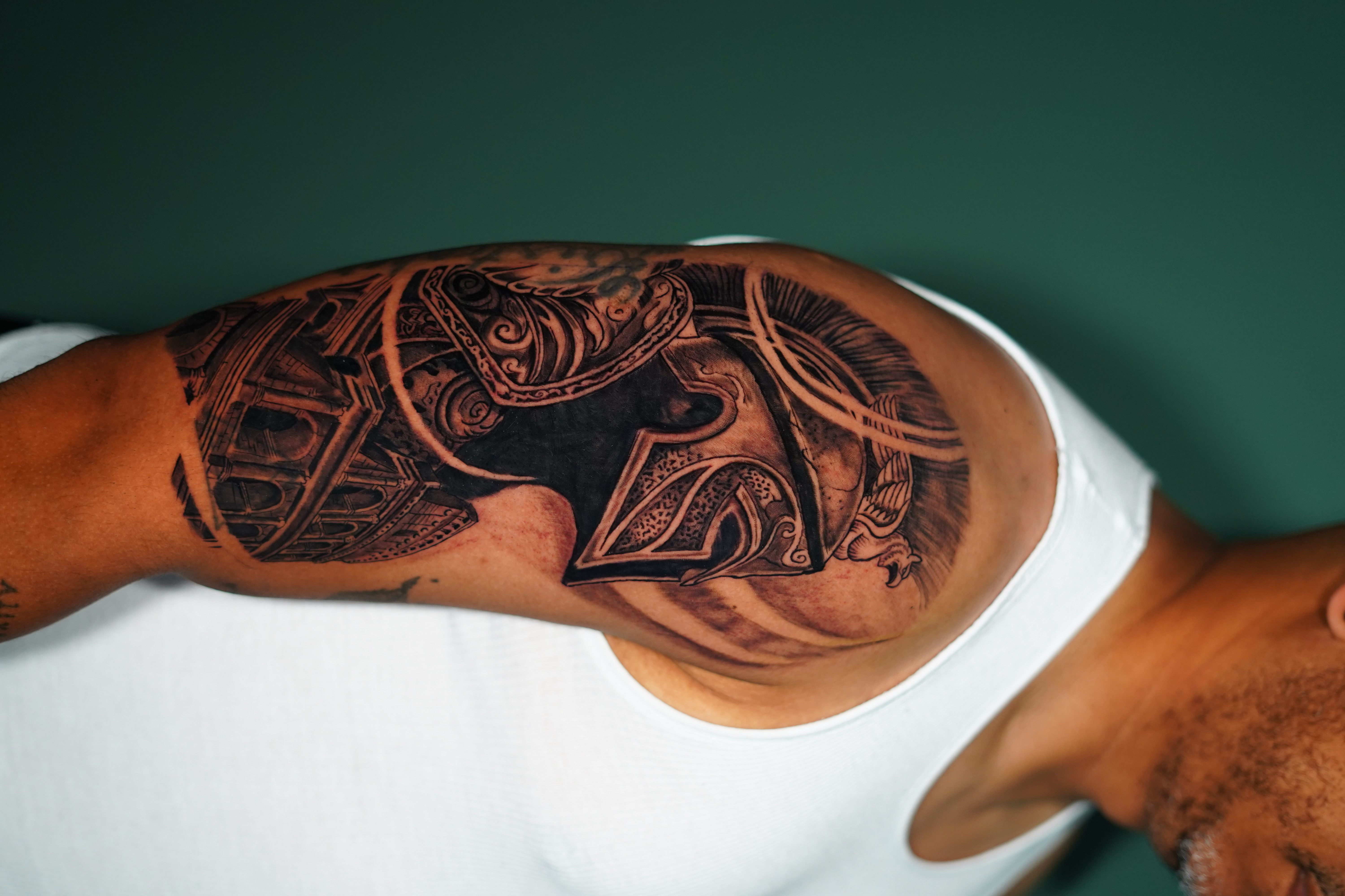 Black & Grey + Illustrative spartan helmet tattoo on Upper Arm by victorm.tattoo on TattMe
