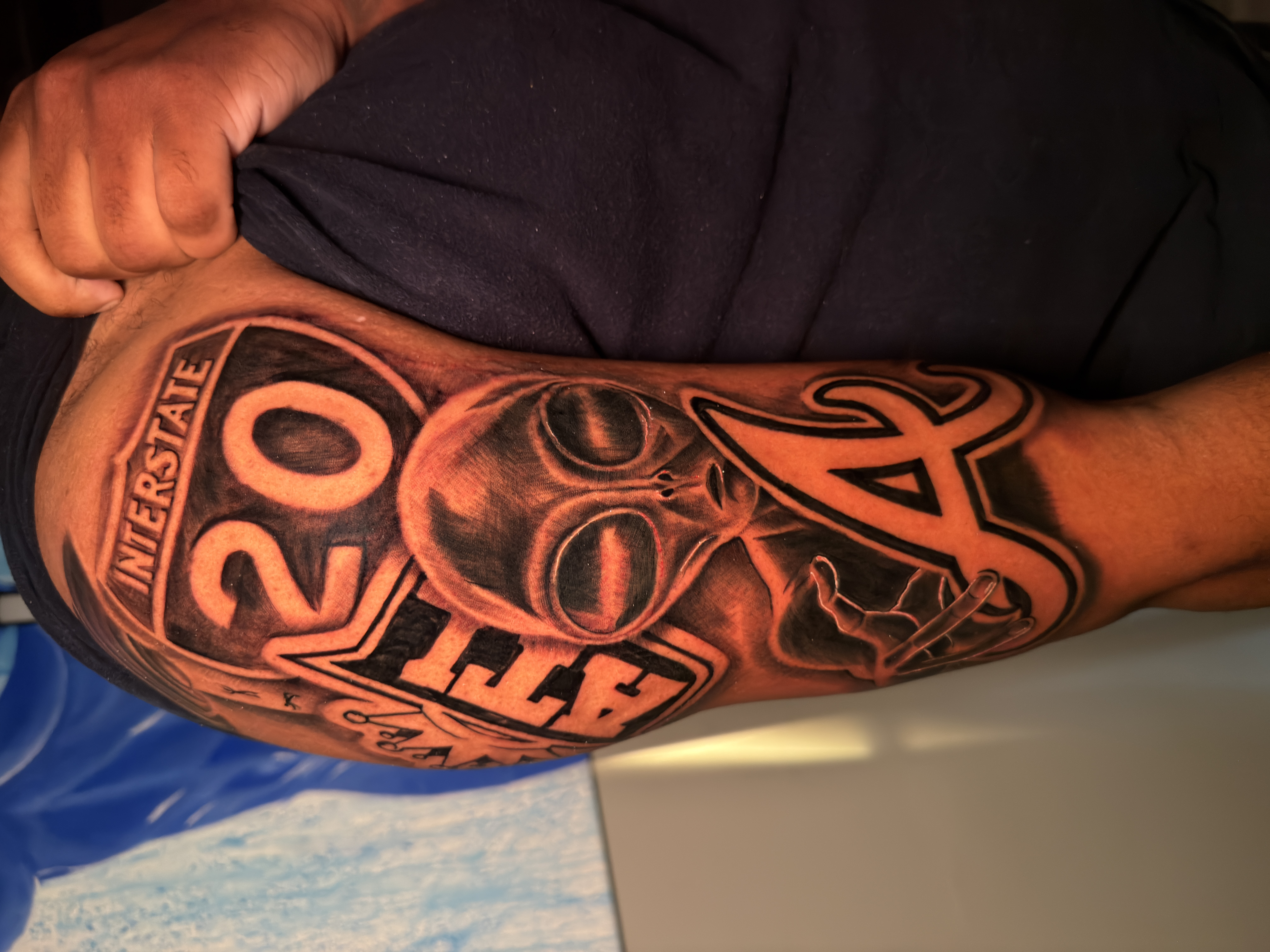 Black & Grey + Lettering alien tattoo on Upper Arm by ARTWORLDINK on TattMe